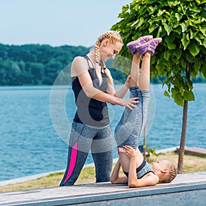 Little girt and woman are doing exercises