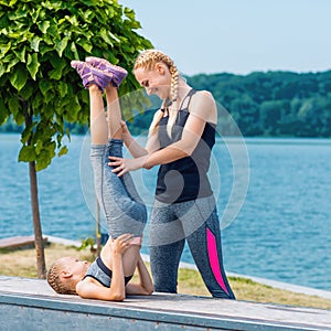 Little girt and woman are doing exercises photo