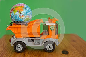 Little globe in garbage truck. Eco concept. photo