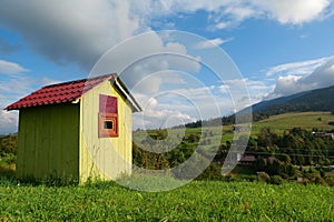 Little green house in mountains