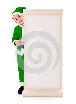 Little green Santa Claus boy pointing at big wish list