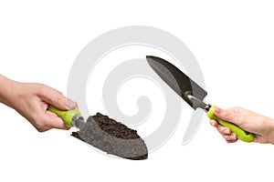 Little green shovel with soil in woman hand isolated