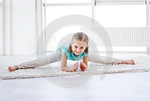 Little gymnast performing twine