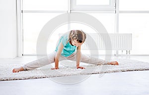 Little gymnast performing twine