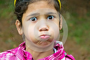 Little gypsy girl child holding breath funny portrait