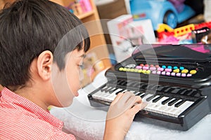 Little hand boy playing small keyboard practice indoor