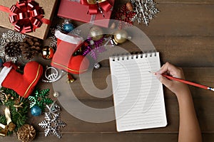 Little hand write on blank note paper with decorations and gift boxes