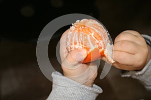 Little hands clean mandarin to have a snack