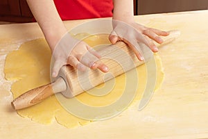 Little hands rolling out dough