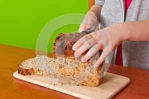 Little hands slicing bread