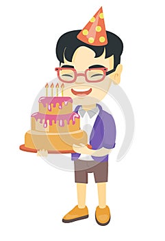 Asian child holding birthday cake with candles