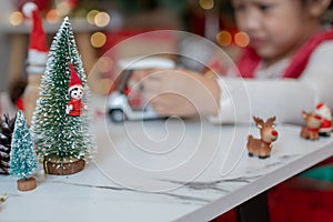 Little happy Asian girl have fun on Christmas party in the living room with decoration