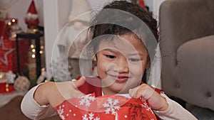 Little happy Asian girl have fun on Christmas party in the living room with decoration