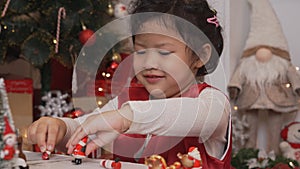 Little happy Asian girl have fun on Christmas party in the living room with decoration