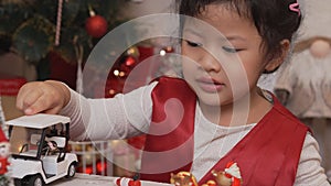 Little happy Asian girl have fun on Christmas party in the living room with decoration