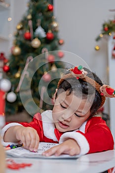 Little happy Asian girl have fun on Christmas party in the living room with decoration