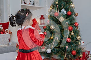 Little happy Asian girl have fun on Christmas party in the living room with decoration