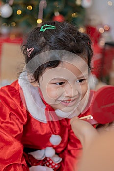 Little happy Asian girl have fun on Christmas party in the living room with decoration