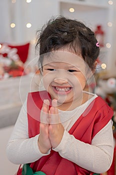 Little happy Asian girl have fun on Christmas party in the living room with decoration