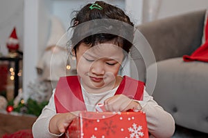 Little happy Asian girl have fun on Christmas party in the living room with decoration