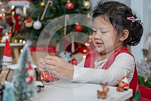 Little happy Asian girl have fun on Christmas party in the living room with decoration