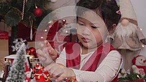 Little happy Asian girl have fun on Christmas party in the living room with decoration at home