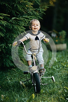 Little happy boy on bike