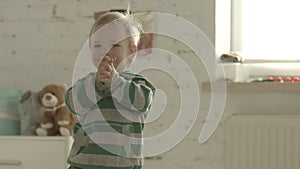 Little happy boy clapping.