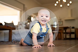 Little happy boy crawling on floor