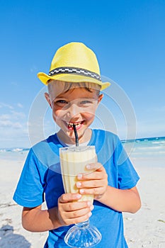 Little boy drinking cocktail on tropical beach