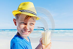 Little boy drinking cocktail on tropical beach