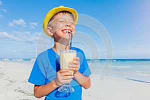 Little boy drinking cocktail on tropical beach