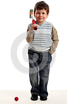 Little happy boy plays mini golf