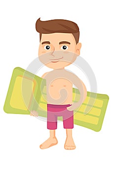 Little caucasian boy holding inflatable mattress.