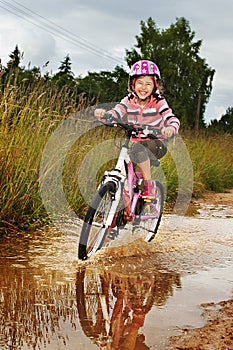 Little happy girl on bike