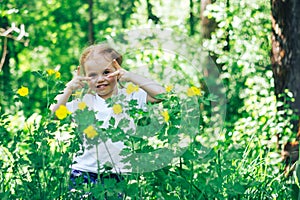 Little happy girl in forest look at camera