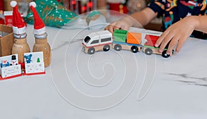 Little happy girl playing train toy and have fun on Christmas party in the living room with decoration