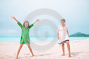 Little happy kids have a lot of fun at tropical beach playing together