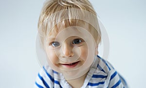 Little, happy and smiling cute baby in the studio. Portrait of a one year old baby. The concept of happiness.