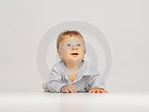 Little, happy and smiling cute baby in the studio. Portrait of a one year old baby. The concept of happiness.