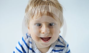 Little, happy and smiling cute baby in the studio. Portrait of a one year old baby. The concept of happiness.