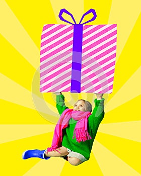 Little happy smiling girl, baby, child holding giant present box over yellow background. Contemporary art collage