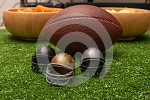 Little helmets  american football ball and snacks on green grass