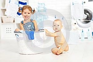 Little helpers funny kids happy sister and brother in laundry to