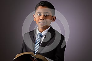 Little Hispanic Boy Holding the Holy Scriptures, The Word of God, The Bible