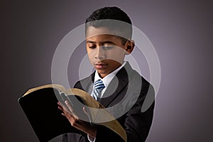 Little Hispanic Boy Reading the Holy Scriptures, The Bible, The Word of God