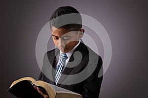 Little Hispanic Boy Reading the Holy Scriptures, The Bible, The Word of God