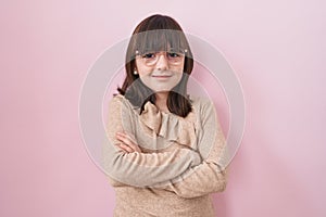 Little hispanic girl wearing glasses happy face smiling with crossed arms looking at the camera