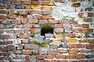 Little hole in an old brick wall