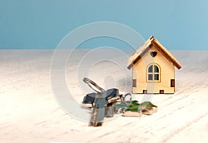 The little house next to it is the keys. Symbol of hiring a house for rent, selling a home, buying a home, a mortgage.